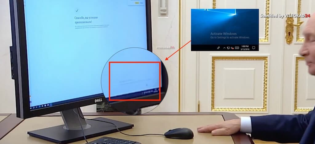 Persona usando computadora con pantalla que muestra mensaje de Windows sin activar en entorno de oficina moderna.